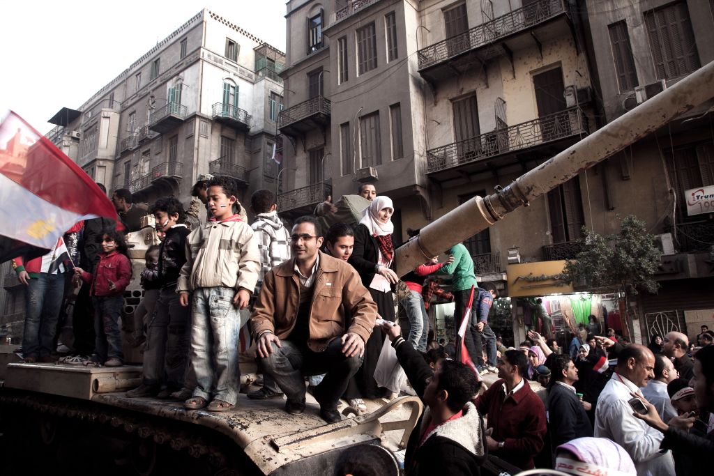 CAIRO, EGYPT - FEBRUARY 13: Egyptians celebrate the revolution in Tahrir Square by posing for photos with Army tanks on February 13, 2011 in downtown Cairo, Egypt. (Photo by Kim Badawi/Getty Images)