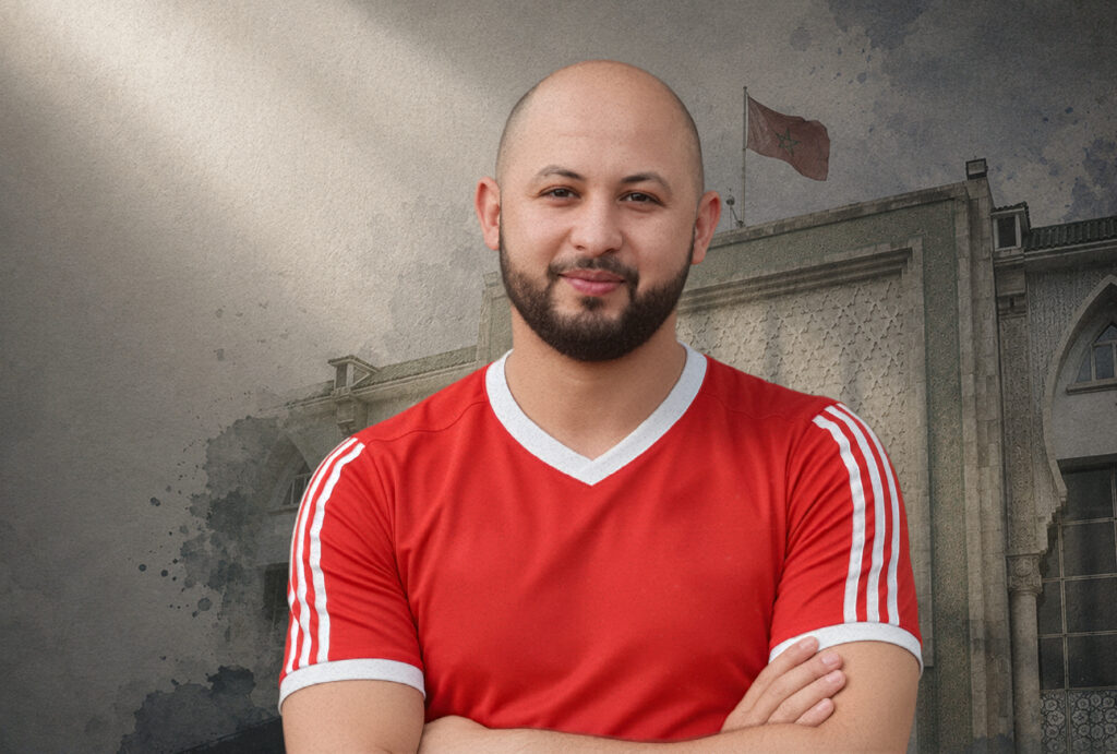 Mourad Habal with a Moroccan court and Moroccan flag in the background