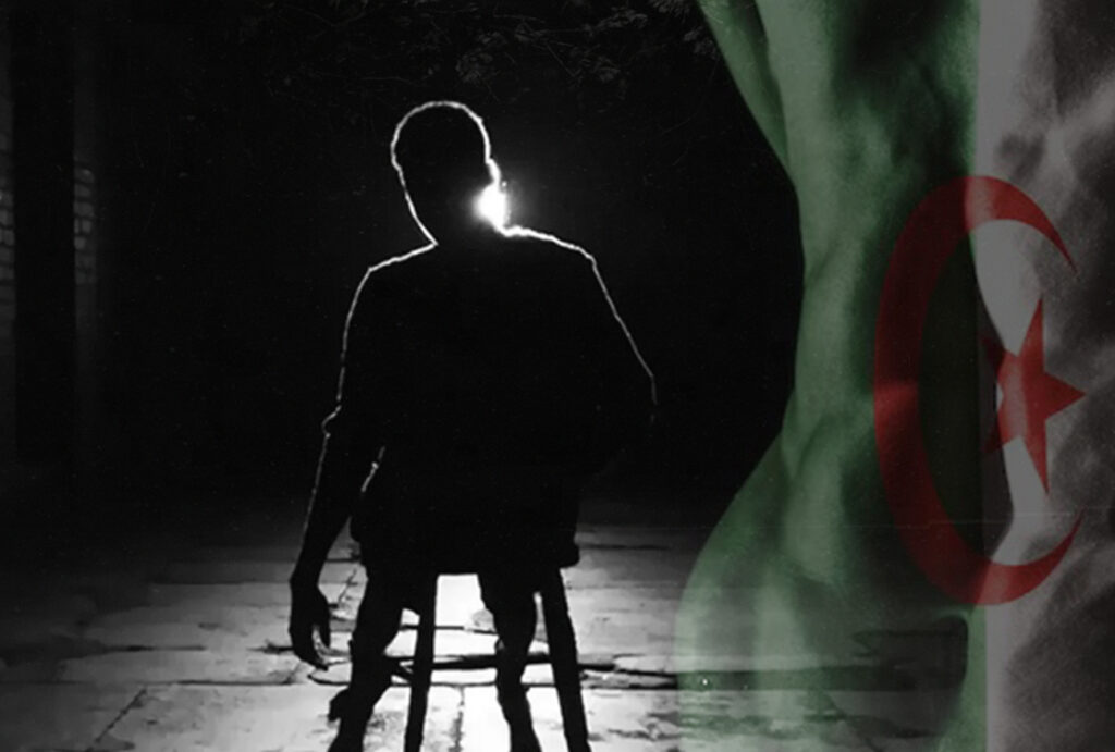 Silhouetted person seated in darkness with the Algerian flag in the background, representing enforced disappearances in Algeria